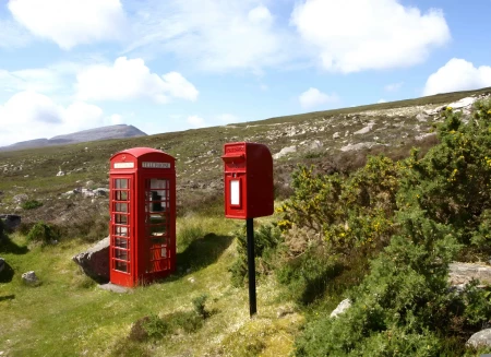 Telephone box and postbox in the countryside